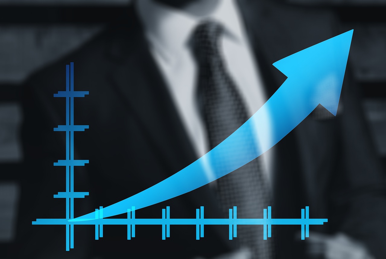 Businessman with an upward trend line overlay symbolizing financial growth.